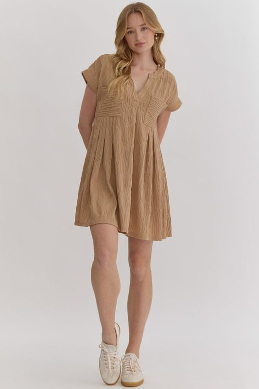 "ADAYLNN" Solid textured short sleeve v-neck mini dress featuring pockets at bust.