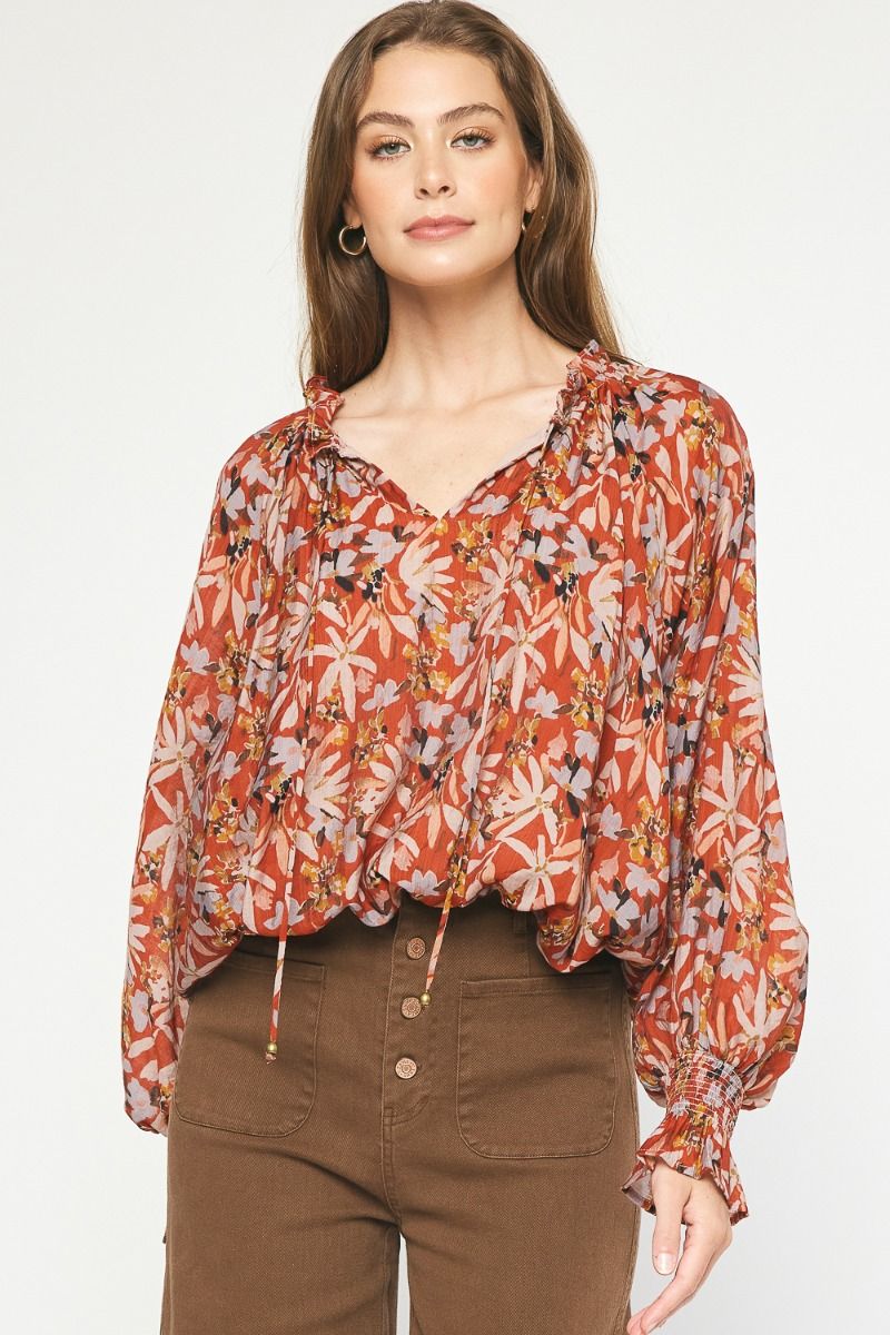 "IOWA" Floral print long sleeve top featuring self-tie detail at ruffled neckline.